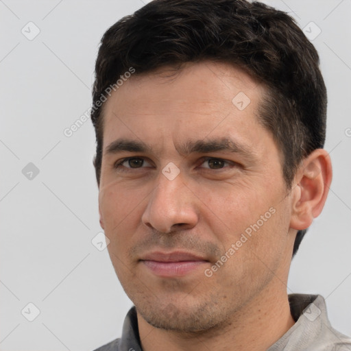 Joyful white adult male with short  brown hair and brown eyes