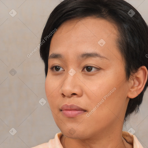 Joyful asian young-adult female with short  brown hair and brown eyes