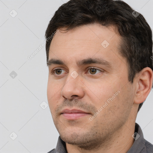 Joyful white adult male with short  brown hair and brown eyes