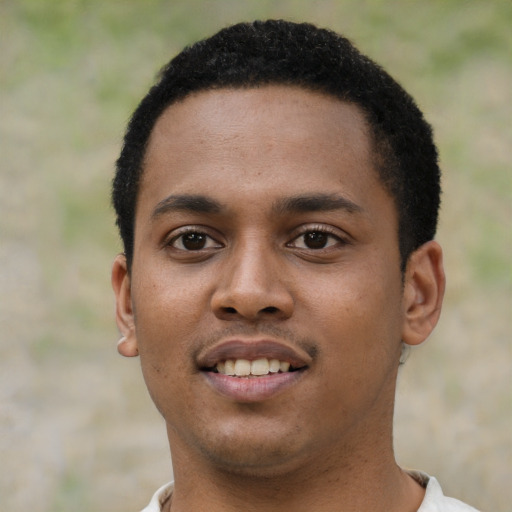 Joyful black young-adult male with short  black hair and brown eyes