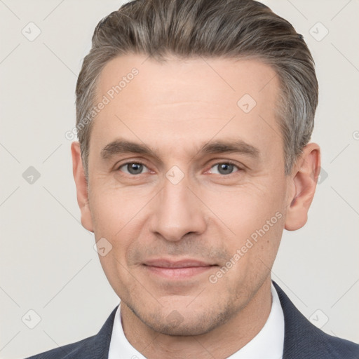 Joyful white adult male with short  brown hair and brown eyes