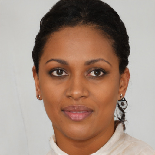 Joyful black young-adult female with short  brown hair and brown eyes