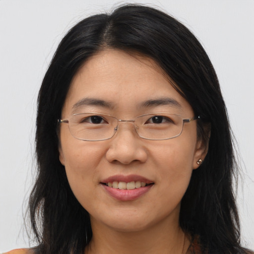 Joyful asian adult female with long  brown hair and brown eyes