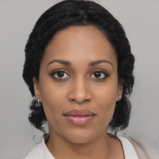 Joyful black young-adult female with medium  black hair and brown eyes