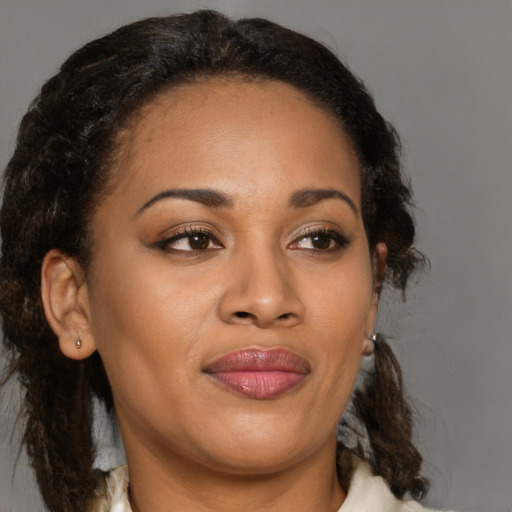Joyful black adult female with medium  brown hair and brown eyes