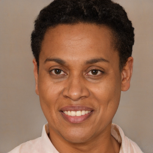 Joyful latino adult female with short  black hair and brown eyes