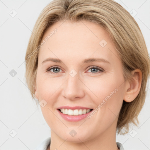 Joyful white young-adult female with medium  brown hair and blue eyes