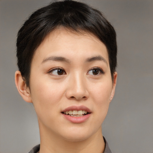 Joyful asian young-adult female with short  brown hair and brown eyes