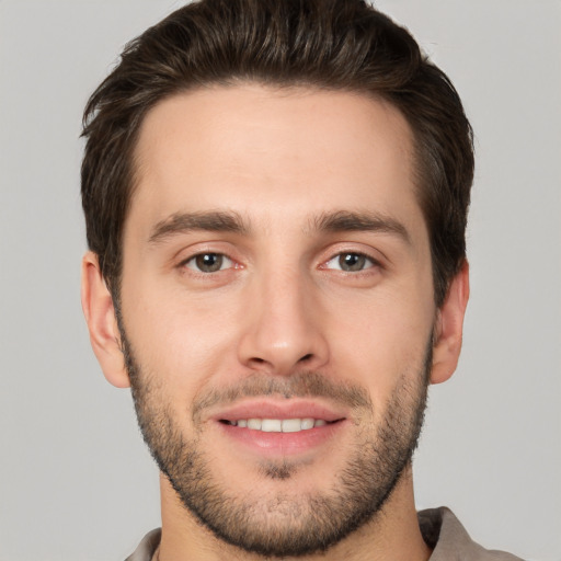 Joyful white young-adult male with short  brown hair and brown eyes