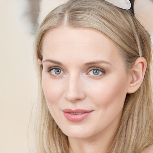 Joyful white young-adult female with long  brown hair and blue eyes