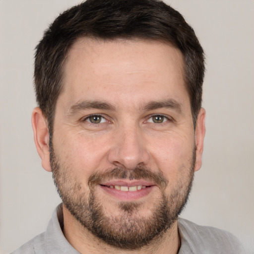 Joyful white adult male with short  brown hair and brown eyes