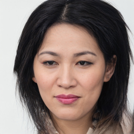 Joyful asian young-adult female with long  brown hair and brown eyes