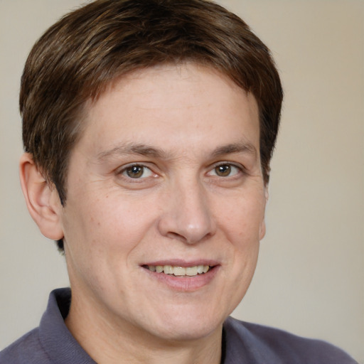 Joyful white adult male with short  brown hair and grey eyes