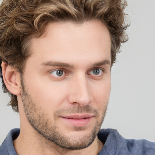 Joyful white young-adult male with short  brown hair and blue eyes