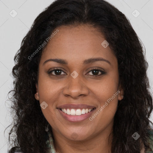 Joyful black young-adult female with long  brown hair and brown eyes