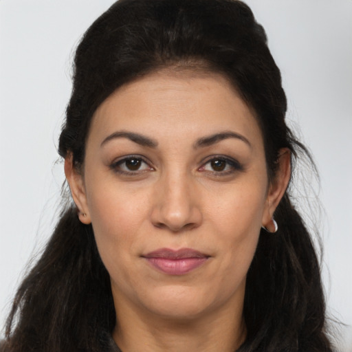 Joyful latino young-adult female with long  brown hair and brown eyes