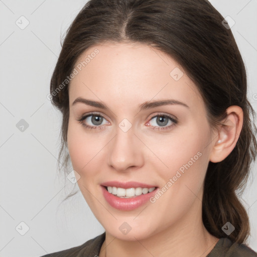 Joyful white young-adult female with medium  brown hair and grey eyes