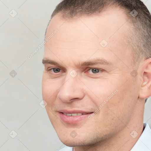 Joyful white adult male with short  brown hair and brown eyes