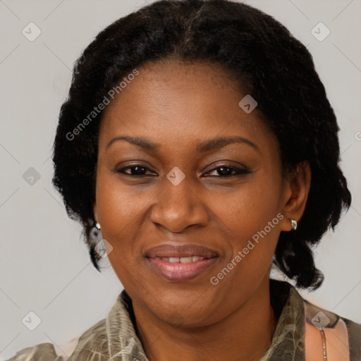 Joyful black adult female with medium  brown hair and brown eyes