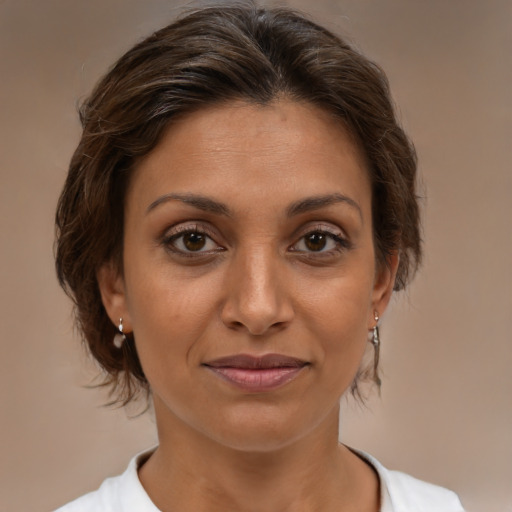 Joyful white adult female with medium  brown hair and brown eyes