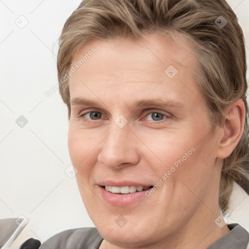 Joyful white young-adult male with medium  brown hair and brown eyes