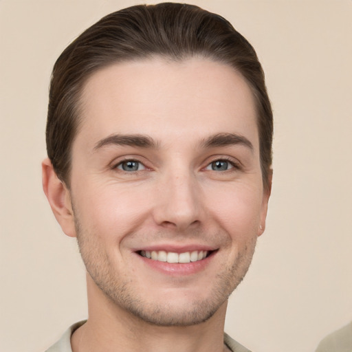 Joyful white young-adult male with short  brown hair and grey eyes