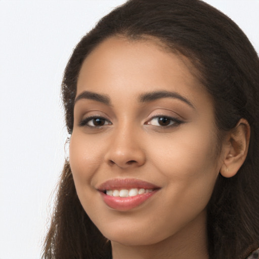 Joyful latino young-adult female with long  brown hair and brown eyes