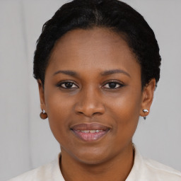 Joyful latino young-adult female with short  black hair and brown eyes