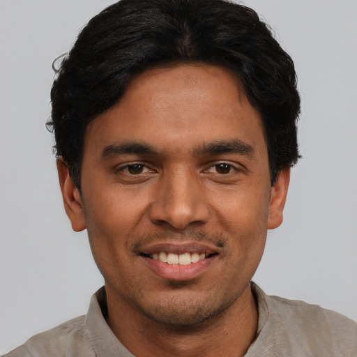 Joyful asian young-adult male with short  black hair and brown eyes