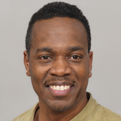 Joyful black young-adult male with short  black hair and brown eyes