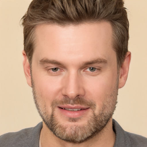 Joyful white adult male with short  brown hair and brown eyes