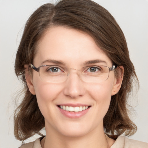 Joyful white young-adult female with medium  brown hair and grey eyes