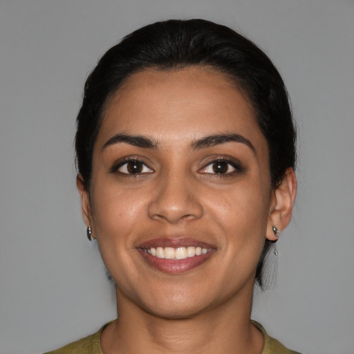 Joyful latino young-adult female with medium  black hair and brown eyes