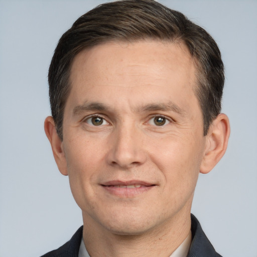 Joyful white adult male with short  brown hair and brown eyes