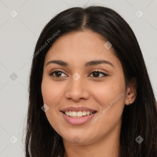 Joyful latino young-adult female with long  brown hair and brown eyes