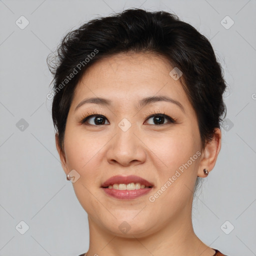 Joyful asian young-adult female with short  brown hair and brown eyes