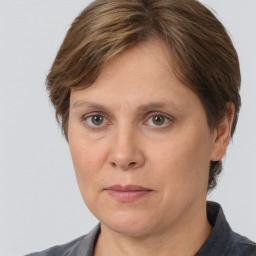 Joyful white adult female with medium  brown hair and grey eyes