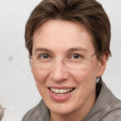 Joyful white adult female with short  brown hair and grey eyes