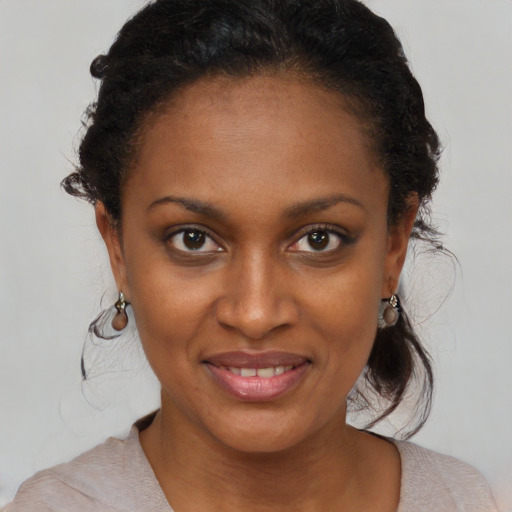 Joyful black young-adult female with medium  brown hair and brown eyes