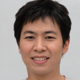 Joyful asian young-adult male with short  brown hair and brown eyes