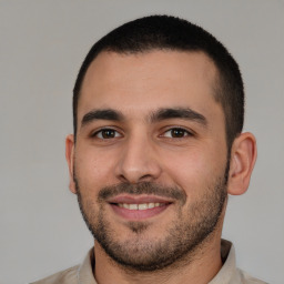 Joyful white young-adult male with short  brown hair and brown eyes