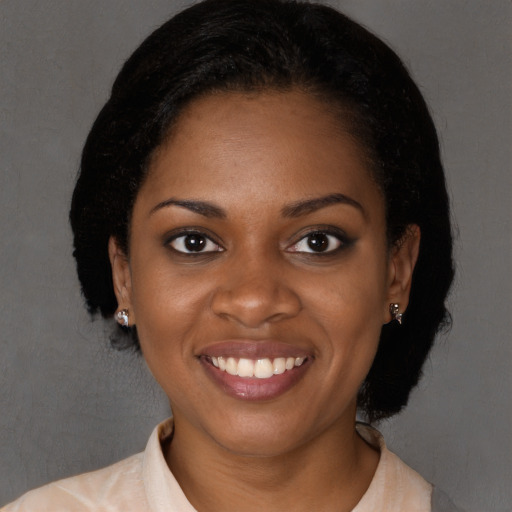 Joyful black young-adult female with long  brown hair and brown eyes