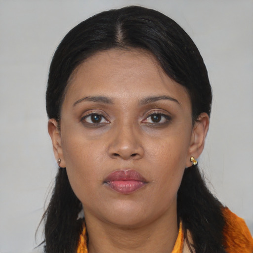 Neutral black young-adult female with medium  brown hair and brown eyes