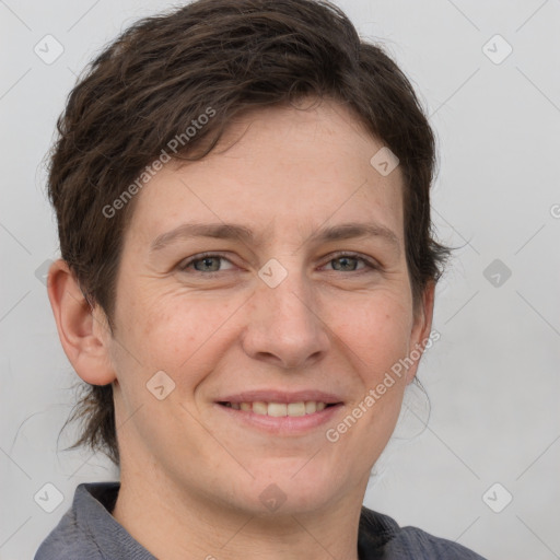 Joyful white adult female with short  brown hair and grey eyes