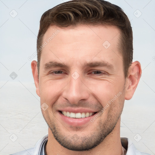 Joyful white young-adult male with short  brown hair and brown eyes