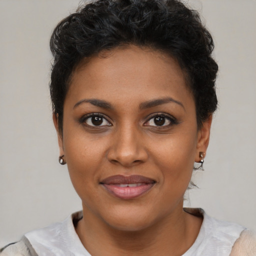 Joyful black young-adult female with short  brown hair and brown eyes