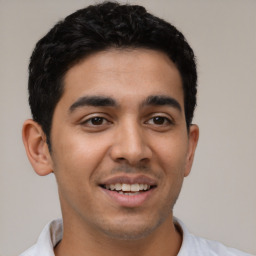 Joyful latino young-adult male with short  black hair and brown eyes