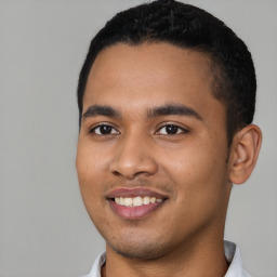 Joyful latino young-adult male with short  black hair and brown eyes