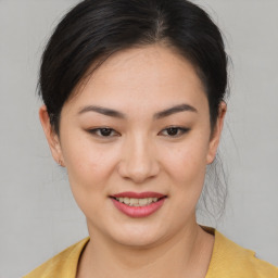 Joyful asian young-adult female with medium  brown hair and brown eyes