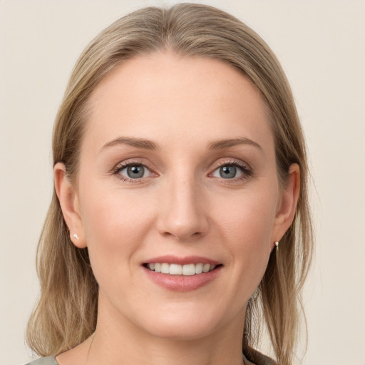 Joyful white young-adult female with long  brown hair and blue eyes